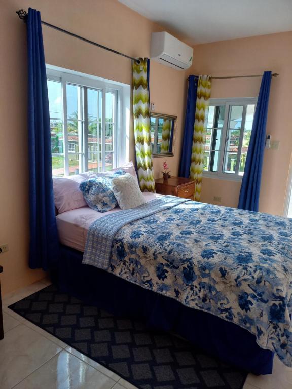 Bright bedroom with blue floral bedding and blue curtains